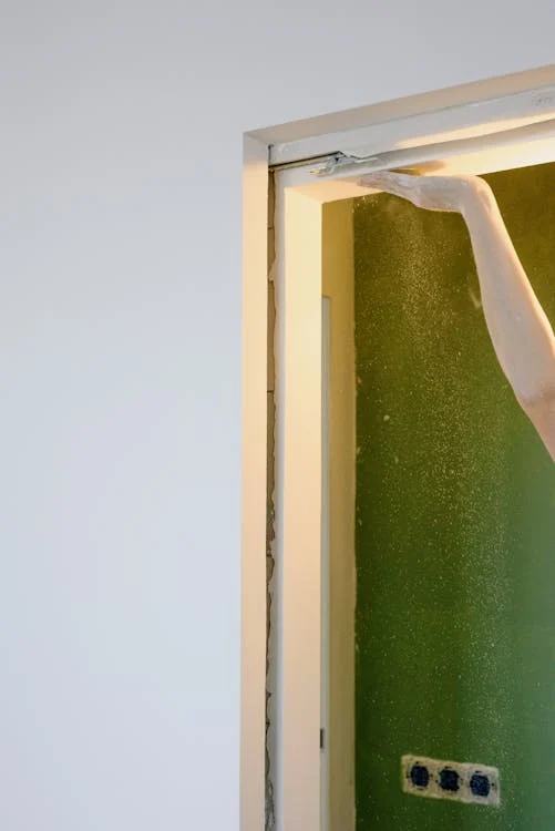 A technician repairing a garage door track.