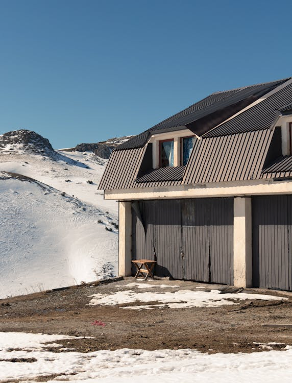 Garage door in winter with snow around it