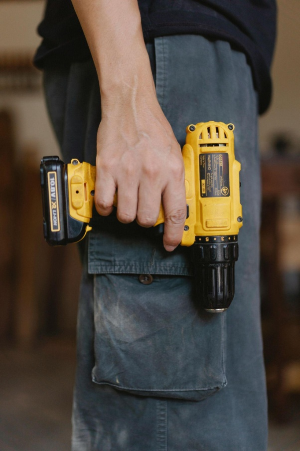 A man holding a Drill