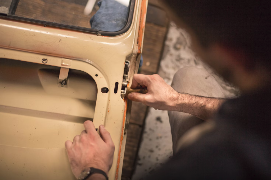 A person inspecting a garage door mechanism.