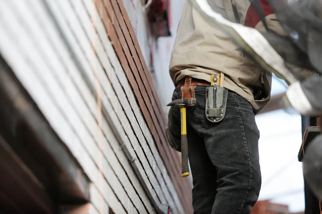 Commercial garage door technician performing repairs