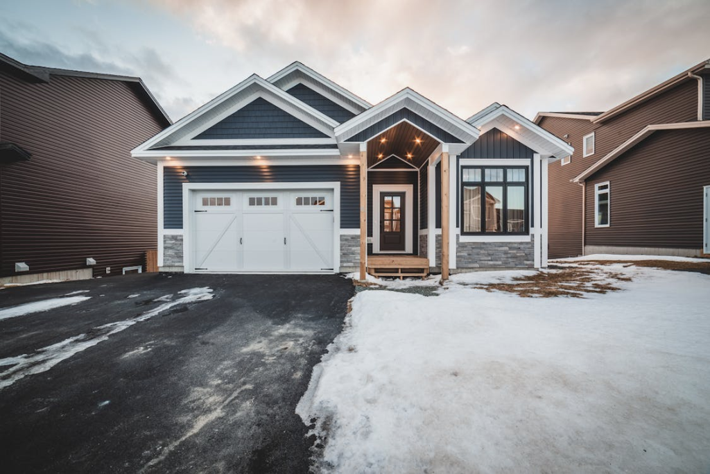 Garage door in winter with snow-covered driveway