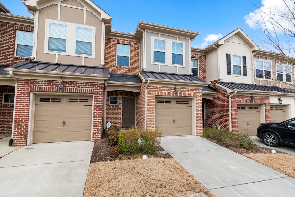 Brick house with traditional garage door and driveway