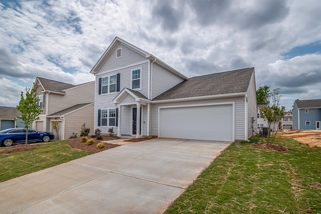 Brick house with traditional garage door and driveway