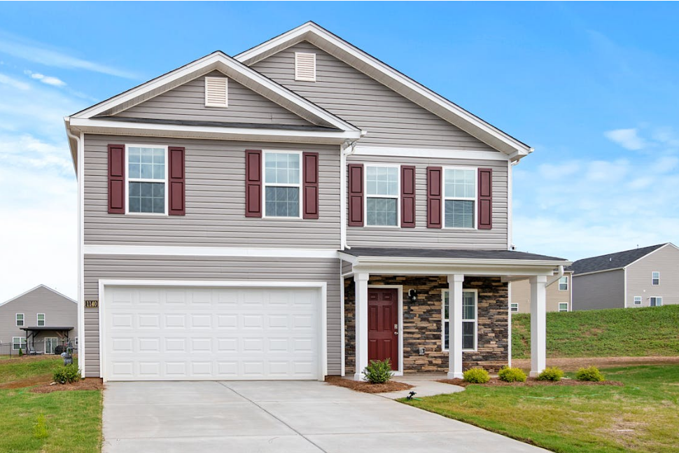 a gray and red house with a white garage door